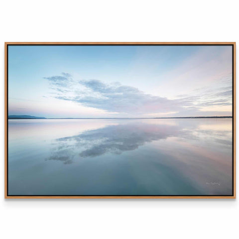 a picture of the sky and water reflecting the clouds