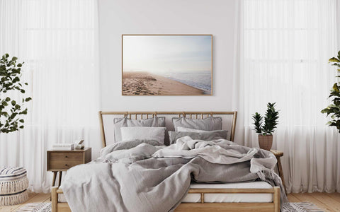 a bedroom with a bed covered in a gray blanket