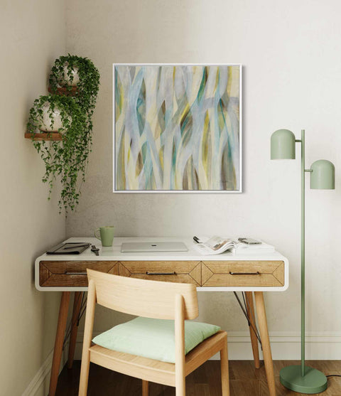 a desk with a chair and a painting on the wall